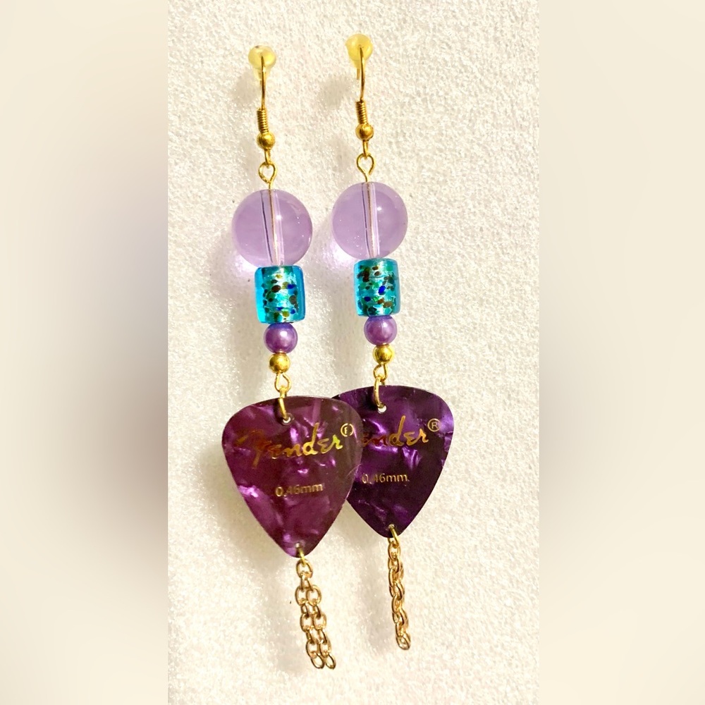 Dangling purple guitar pick earrings with earrings